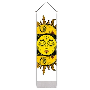 Detail of bohemian sun tapestry featuring yellow celestial face with wood pole and rope