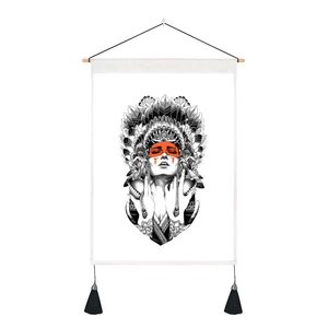 Detail of bohemian art tapestry featuring orange facial accents and black tassels
