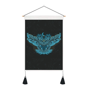 Detail of artistic owl tapestry with moon and stars, blue pattern on black background