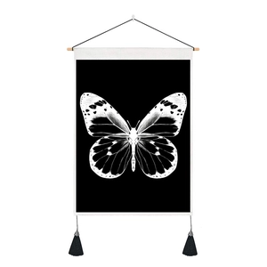 Detail of butterfly wall hanging with wooden rod and black tassels on high-quality canvas