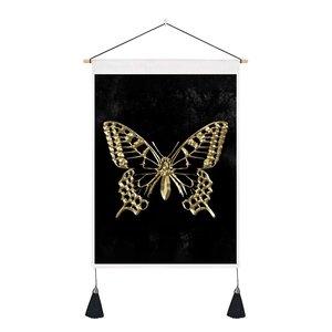 Detail of modern black fabric wall art with a golden butterfly design and black tassels
