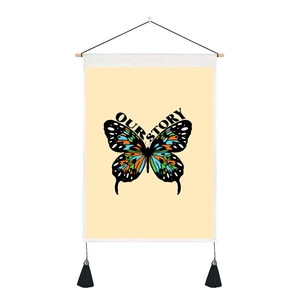 Detail of butterfly tapestry with OUR STORY text, wooden rod, and decorative tassels