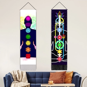 Detail of colorful chakra wall tapestries with tassels in a cozy home interior setting