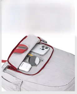 Detail view of foldable travel backpack showing inner storage for phone and accessories