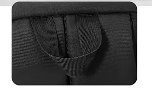 Detailed view of the reinforced top handle on a large black canvas travel backpack