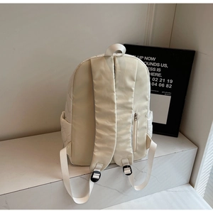 Rear view of quilted cotton backpack showing adjustable straps and hidden zip pocket