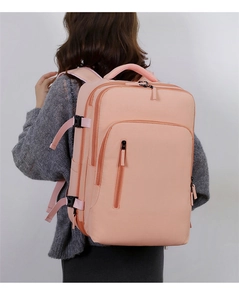 Detailed back view of pink expandable commuter backpack with waterproof fabric on model