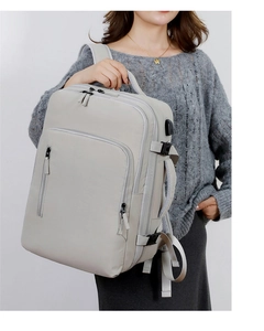 Close-up of light gray laptop backpack featuring integrated side USB charging port