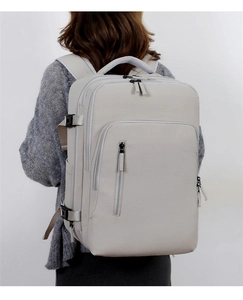 Water-resistant commuter backpack on model showing large capacity and professional grey design
