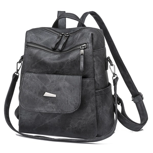 Detail view of black vintage PU backpack with functional zippers and metal geometric hardware