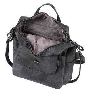 Macro view of multi-pocket backpack interior with grey lining and metal zipper details