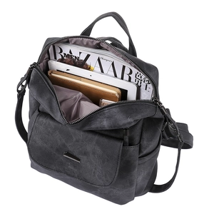 Top view of spacious PU leather backpack interior filled with tablet, magazine and notebook