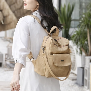 Khaki PU leather backpack for women shown in an outdoor lifestyle setting with dual straps