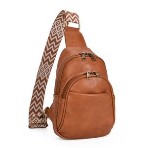 Detail of vintage brown PU leather crossbody bag with geometric pattern wide strap