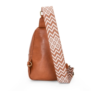 Detail of brown faux leather crossbody bag with geometric pattern wide woven strap