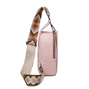Pink PU leather chest bag detail showing vintage hardware and geometric woven strap