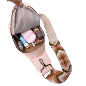 Pink PU crossbody chest bag interior view showing storage capacity with wide jacquard strap