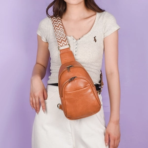 Detail of caramel PU leather crossbody bag with vintage geometric patterned strap