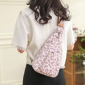 Pink leopard print chest bag with geometric wide strap shown on model's back