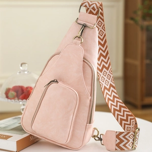 Pink faux leather chest bag with geometric woven strap and vintage metal hardware