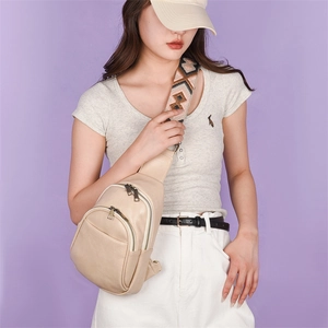 Detail of apricot PU leather chest bag with ethnic geometric pattern wide strap