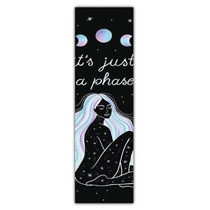 Detail of artistic wall hanging featuring moon phases and mystical girl silhouette