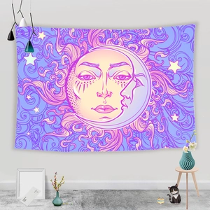 Detail of bohemian sun and moon tapestry on a white wall with home decor accessories