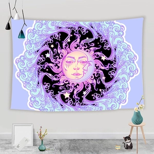 Detail of bohemian sun and moon tapestry with mandala pattern in purple and cyan tones
