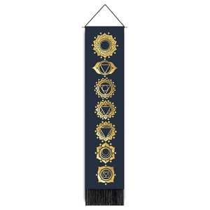 Detailed view of bohemian blue chakra tapestry with golden geometric icons and black tassels