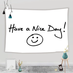 Detail of white fabric tapestry featuring Have a Nice Day print and smiley face design