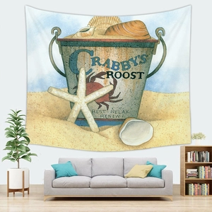 Detail of beach themed wall tapestry featuring a vintage crab bucket over a gray sofa