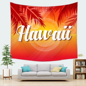 Detail of Hawaii beach sunset wall tapestry with palm leaves hanging above a sofa
