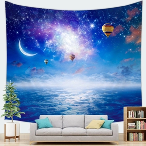 Detail of galaxy tapestry with moon and hot air balloon hanging in a modern living room