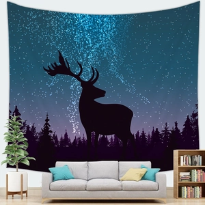 Detail of a large starry sky tapestry with forest and reindeer silhouette in a cozy room