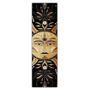 Detail of sun god face tapestry with golden metallic celestial pattern on black fabric