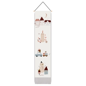 Detailed view of Christmas wall tapestry with wooden rod, tassels and festive illustrations