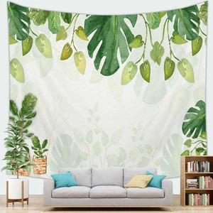 Detailed close-up of a watercolor tropical monstera leaf tapestry on a white living room wall