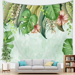 Tropical monstera leaf and floral tapestry displayed in a minimalist living room setting