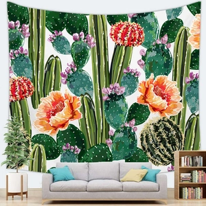 Detail of Nordic cactus floral wall tapestry hanging above a modern grey sofa in a cozy room