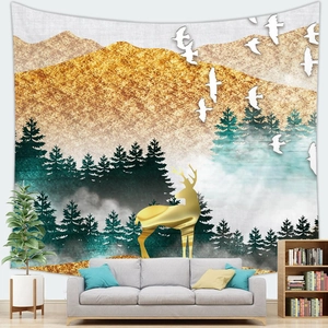 Scenic sunset mountain tapestry with golden deer silhouette hanging above a grey sofa