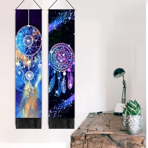 Colorful dreamcatcher star tapestry with black tassels hanging on white wall