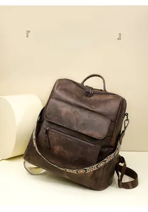 Close-up of vintage brown backpack with bohemian style jacquard shoulder strap