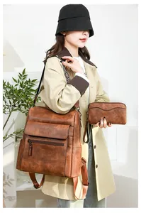Brown vintage faux leather backpack and clutch set with multi-compartment storage pockets