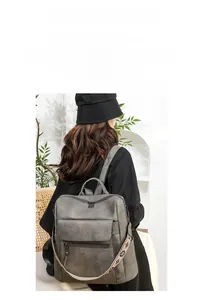 Detail view of dark grey PU leather backpack with vintage floral textured shoulder straps