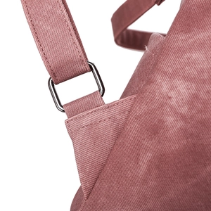 Detail of metal buckle and reinforced stitching on purple fabric backpack strap