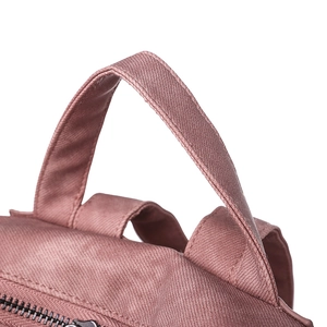 Detail of rose pink textured backpack showing reinforced stitching and metal zipper