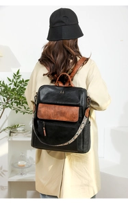 Close-up of women's vintage backpack with ethnic embroidery straps and leather details