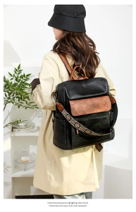 Detailed shot of large capacity leather backpack with colorful bohemian embroidery strap