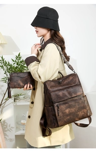 Close-up of retro brown leather backpack with patterned strap worn with a beige coat