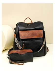 Detail of color-block backpack with bohemian embroidery strap and matching clutch set